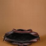 The Brown Hide brown top-grain leather laptop bag open with padded laptop pocket, multiple organizers and metal hardware